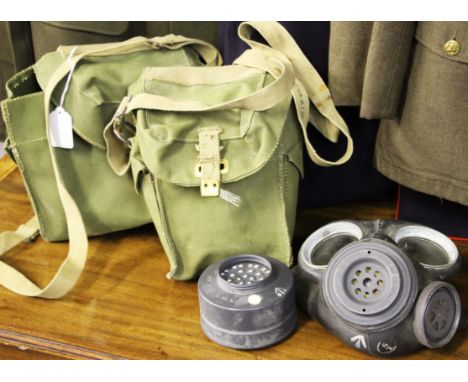 A lot to include; two British army black gas masks in green bags, group of eleven leather auxiliary straps with buckles and t