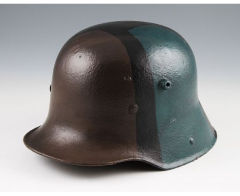 A German M16 helmet with liner, overall later repainted with camo design to exterior.
