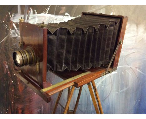 A mahogany and brass field camera with three plates, two lenses and a tripod base made by Albion Albumenizing, Glasgow.