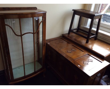 A walnut glazed front display cabinet, two oak blanket boxes and one oak stool.