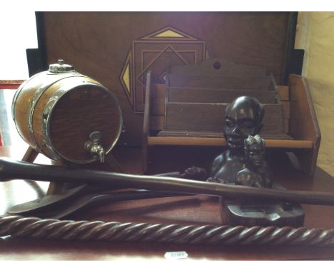 A box containing a letter rack, a book rack, an African twist ash tray stand, fossil slate, an African stick, various African