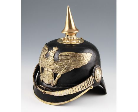 A German WW1 officers Prussian Pickelhaube helmet, having bras Mitt Gott Fur Koenig Und Vaterland badge to front with leather