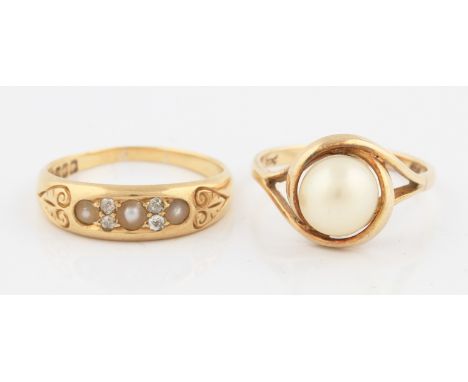 An 18ct yellow gold pearl and diamond ring, set with three half pearls interspersed with old cut diamond accents, hallmarked 