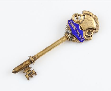 A silver gilt and enamel key, engraved 'The C.G.H.S. Co. Ltd. Sept 27th 1911 Grand Palace', hallmarked Birmingham 1911, with 