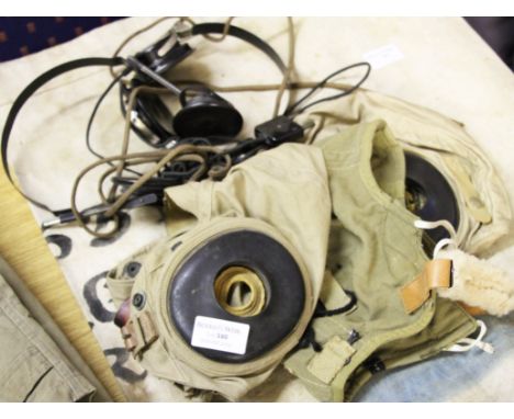 Three US army air force flying helmets, two with headphones.
