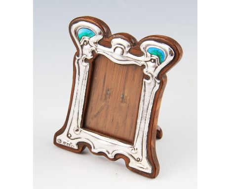 An Art Nouveau silver and enamel photograph frame, the upper lobed design featuring two blue/green enamel panels, hallmarked 