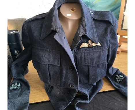 A 1945 dated RAF tunic with wing cloth badges together with torso mannequin.