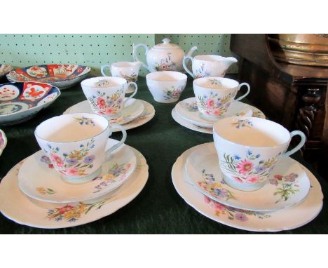 An early 20th century Shelley part-tea service in the Wild Flowers pattern, no. 13668, comprising: teapot, milk jug, cream ju