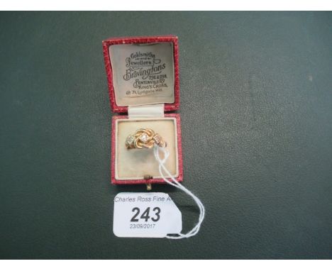 An 18ct gold gem set ring of rope twist form.
