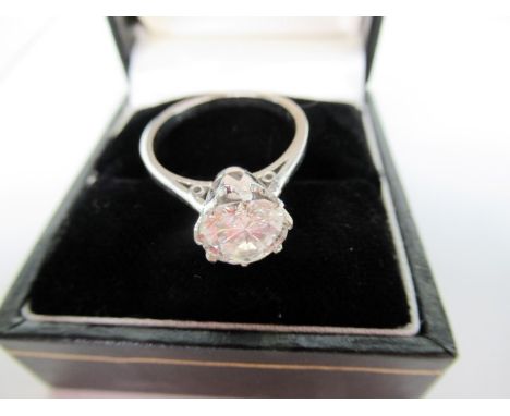 A single stone diamond ring, the brilliant cut diamonds in simple claw mounts to raised tapered shoulders, plain precious whi