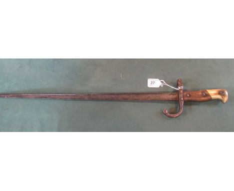 An early 20th century rifle bayonet, French, having impressed marks to the handle and no. 75175, the blade 52cm.