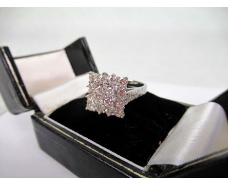 A diamond cluster ring, the square shape cluster set with brilliant cut diamonds within raised claw mounts, to a textured 18c