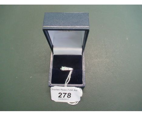 An 18ct white gold diamond ring, set with one millennium cut diamond in a part rub-over setting, each shoulder set with three