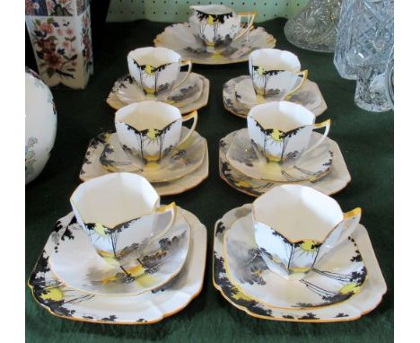 An early 20th century Shelley part-tea service, in the Sunset and Tall Trees pattern, Queen Anne shape no. 11678 and registra