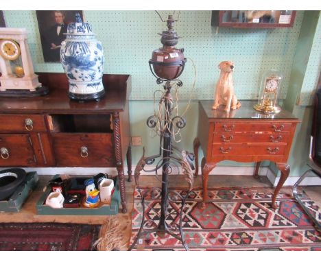 A late Victorian floor standing oil lamp of scrollwork form, later converted to electricity, 136cm.