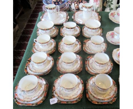 An Edwardian bone china part-tea service, comprising: ten trios, two sandwich plates, two milk jugs and two sugar bowls.