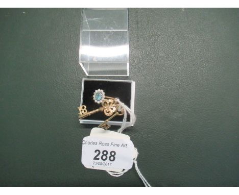 A blue topaz cluster ring to a 9ct shank, together with a 9ct gold 'Key of the Door' charm and another, similar.