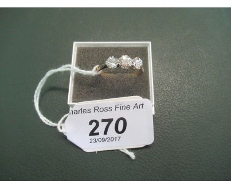 A lady's three stone diamond ring, to an 18ct gold plain shank, the three stones set in platinum law mounts.