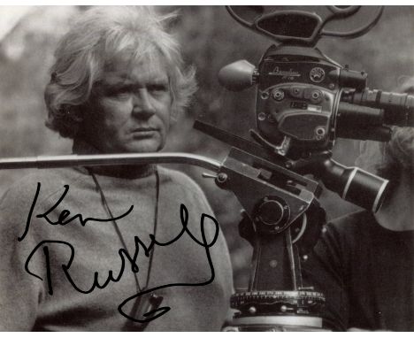 RUSSELL KEN: (1927-2011) British film director. Signed 10 x 8 photograph of Russell standing in a half-length pose alongside 