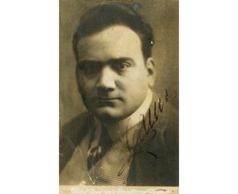 CARUSO ENRICO: (1873-1921) Italian Tenor. Signed postcard photograph by Caruso, with Christmas greeting in his hand to the ve