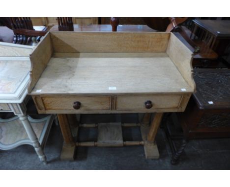 A Victorian Gothic Revival light oak two drawer wash stand 