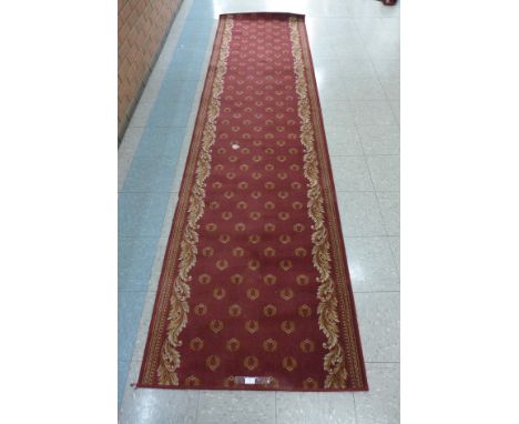 A red ground Wilton runner rug, 91 x 210cms 