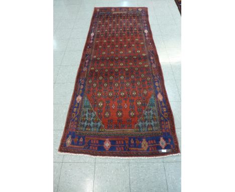 A red ground Persian Joshaghan runner rug, 112 x 270cms 