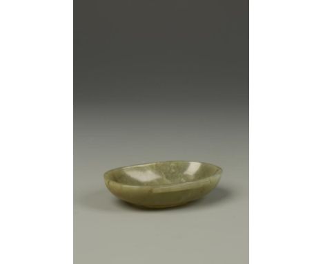 A SMALL CHINESE GREEN JADE EAR CUP, of oval form, with two side lugs, late Ming-early Qing, 3" long