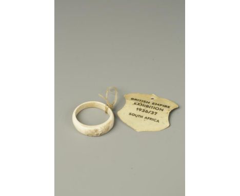 A JAPANESE IVORY RING carved with a monkey, Meiji-Taisho, apparently bought from The British Empire Exhibition 1936/7 in Sout