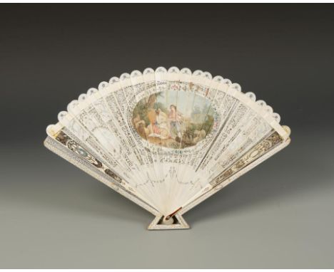 AN IVORY BRISEE TYPE FAN decorated with a central oval panel depicting a shepherd and shepherdess in a naturalised landscape,