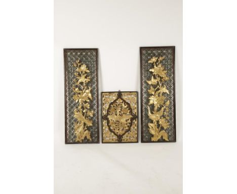 THREE CHINESE GILTWOOD PANELS, including a pair showing birds among flowers on a open-fret ground, Qing, 19th century, 46" x 