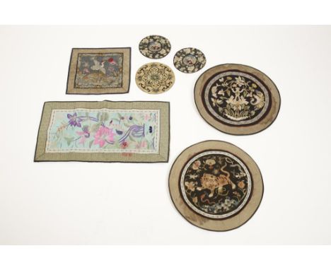 SEVEN CHINESE SILK-EMBROIDERED PANELS including a rank badge, five roundels and a rectangular panel, late Qing-Republic, the 