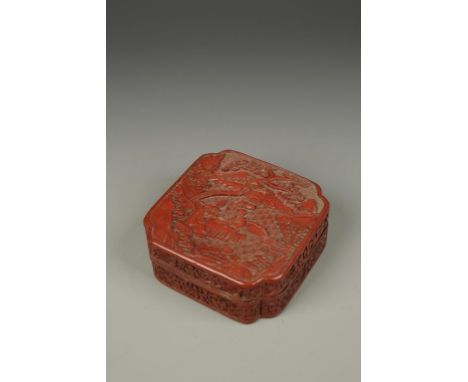 A CHINESE CINNABAR LACQUER QUATREFOIL BOX, the cover decorated with three scholars seated at a table in a wood and mountain l