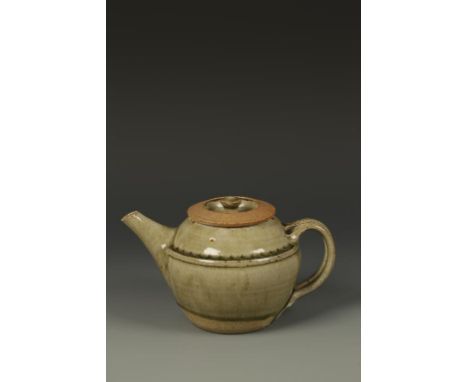 RICHARD BATTERHAM (b.1936) A STONEWARE TEAPOT AND COVER of rounded form with a celadon glaze, 5.25" high. See illustration