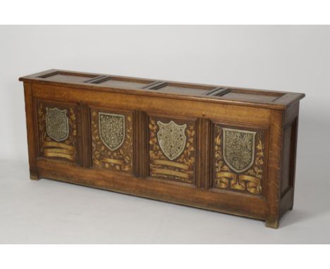 AN AMORIAL PAINTED OAK COFFER, the four panel front painted with armorial shields, with a four panel rising top, Victorian, 2