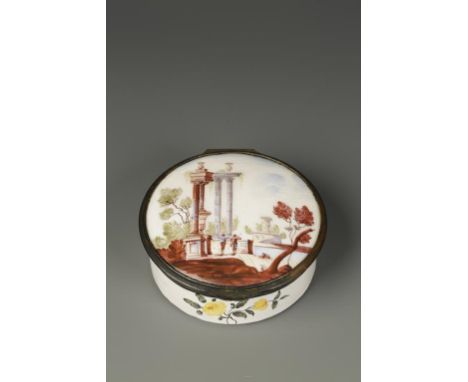 A SOUTH STAFFORDSHIRE ENAMEL PILL BOX of circular form, the lid decorated with two gentlemen amongst ruins, circa 1760, 3" wi
