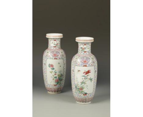 A PAIR OF CHINESE FAMILLE ROSE VASES, decorated with panels of butterflies and flowers on a dense foliate scroll ground, late