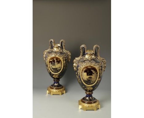 A PAIR OF LARGE CHOISY DE ROI VASES, decorated in gilt on a dark blue ground with landscapes in ribbon-tie panels, reserved o