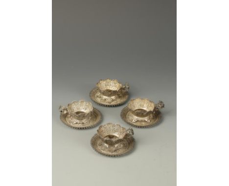 A SET OF FOUR INDIAN SILVER FILIGREE CUPS AND SAUCERS, of foliate form, late 19th/early 20th century, the saucers 3.5" dia. (