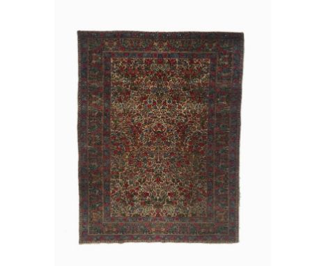 A PERSIAN 'GARDEN PATTERN' RUG, with a central panel worked with trees and flowers against a cream ground, within a multiguar