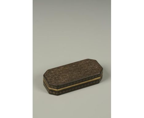 A CONTINENTAL PIQUE WARE SNUFF BOX of rectangular form with canted corners, the top inset with scrolling repeated decoration,