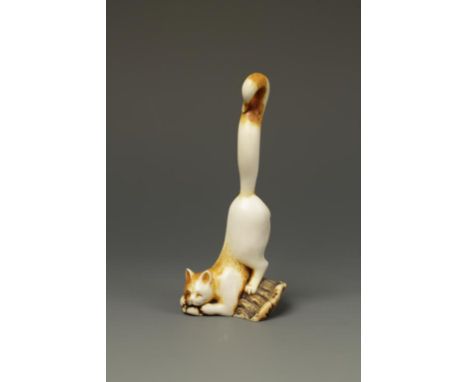 A STAG ANTLER CAT-FORM NETSUKE BY GUY SHAW, the animal with a pleased expression catching a mouse with its hind quarters and 