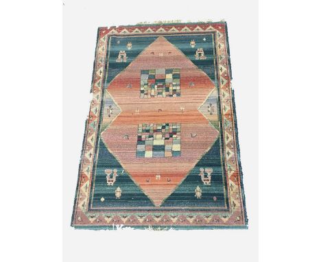 A MODERN 'AFGHAN' TYPE RUG worked with geometric patterns against a varied lozenge shaped panel, against a blue ground, with 