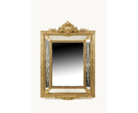 AN ITALIANATE GILT FRAMED WALL MIRROR with a central rectangular plate with bevelled edges flanked by four plates with cut an