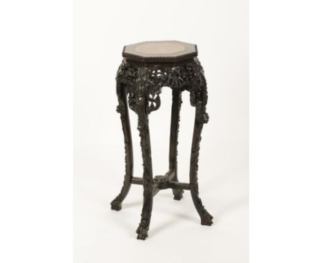 A CHINESE HARDWOOD MARBLE TOPPED STAND with an octagonal top with central marble panel on an outswept border of pierced and c