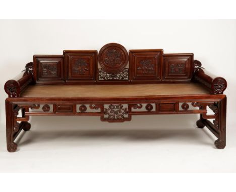 A LARGE CHINESE HARDWOOD DAY BED, probably hongmu, the back with a central roundel and four square panels carved with vases o