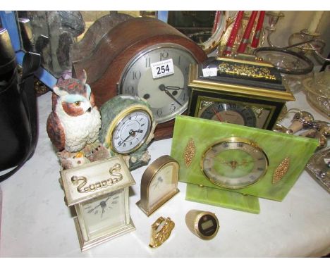 An oak mantel clock and several other clocks
