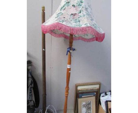 A standard lamp with shade and a lamp base