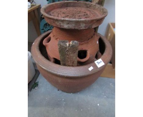 A large pottery garden pot and an earthenware planter