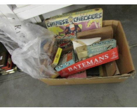 A box of interesting old games and a puppet